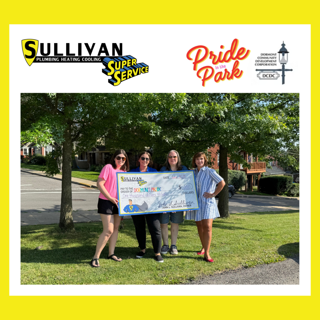Four women stand outdoors holding a large check from Sullivan Plumbing Heating Cooling, with sponsor logos and “Pride in the Park” visible on a yellow-bordered graphic.