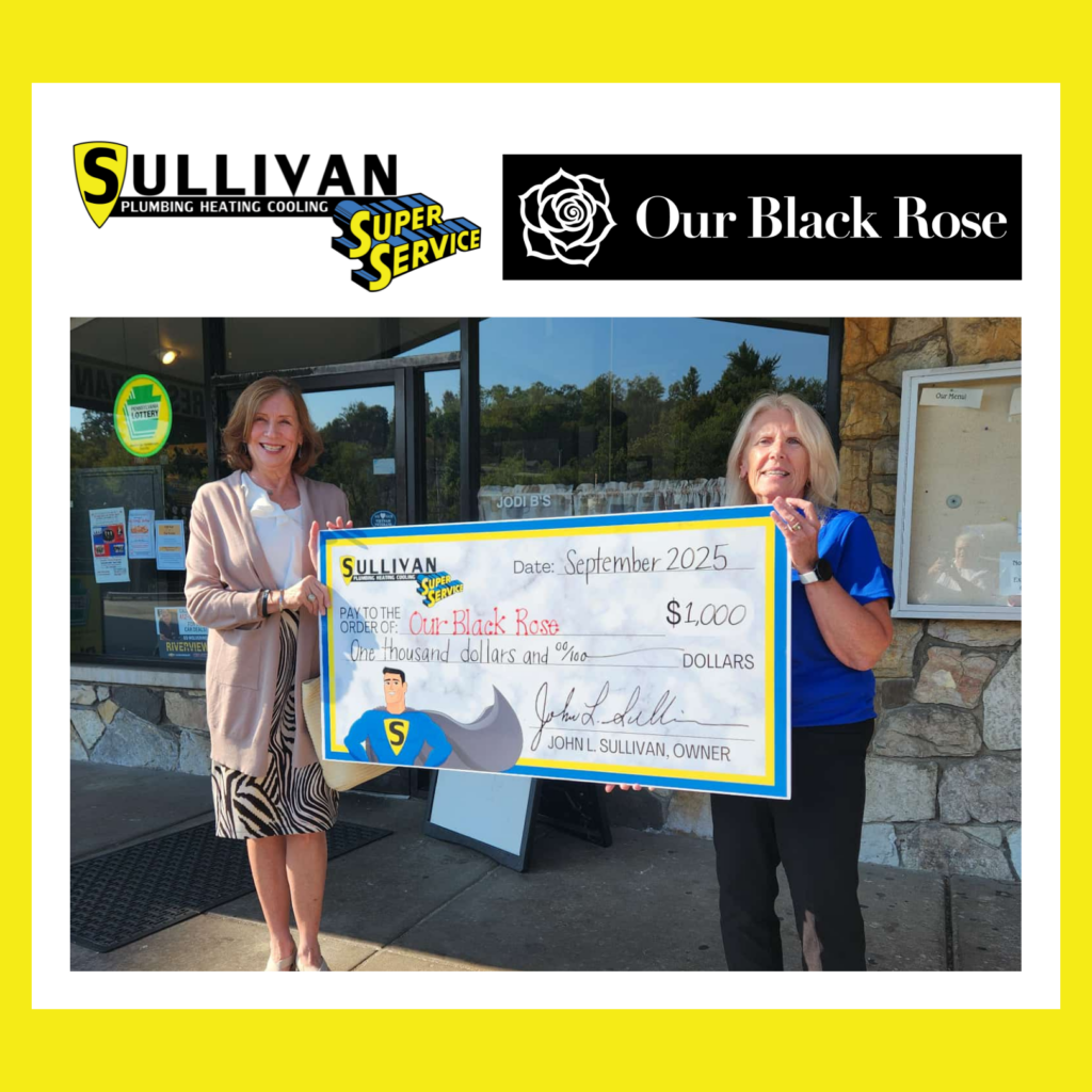 Two women stand outside holding an oversized check for $1,000 made out to "Our Black Rose," with Sullivan Plumbing branding visible.